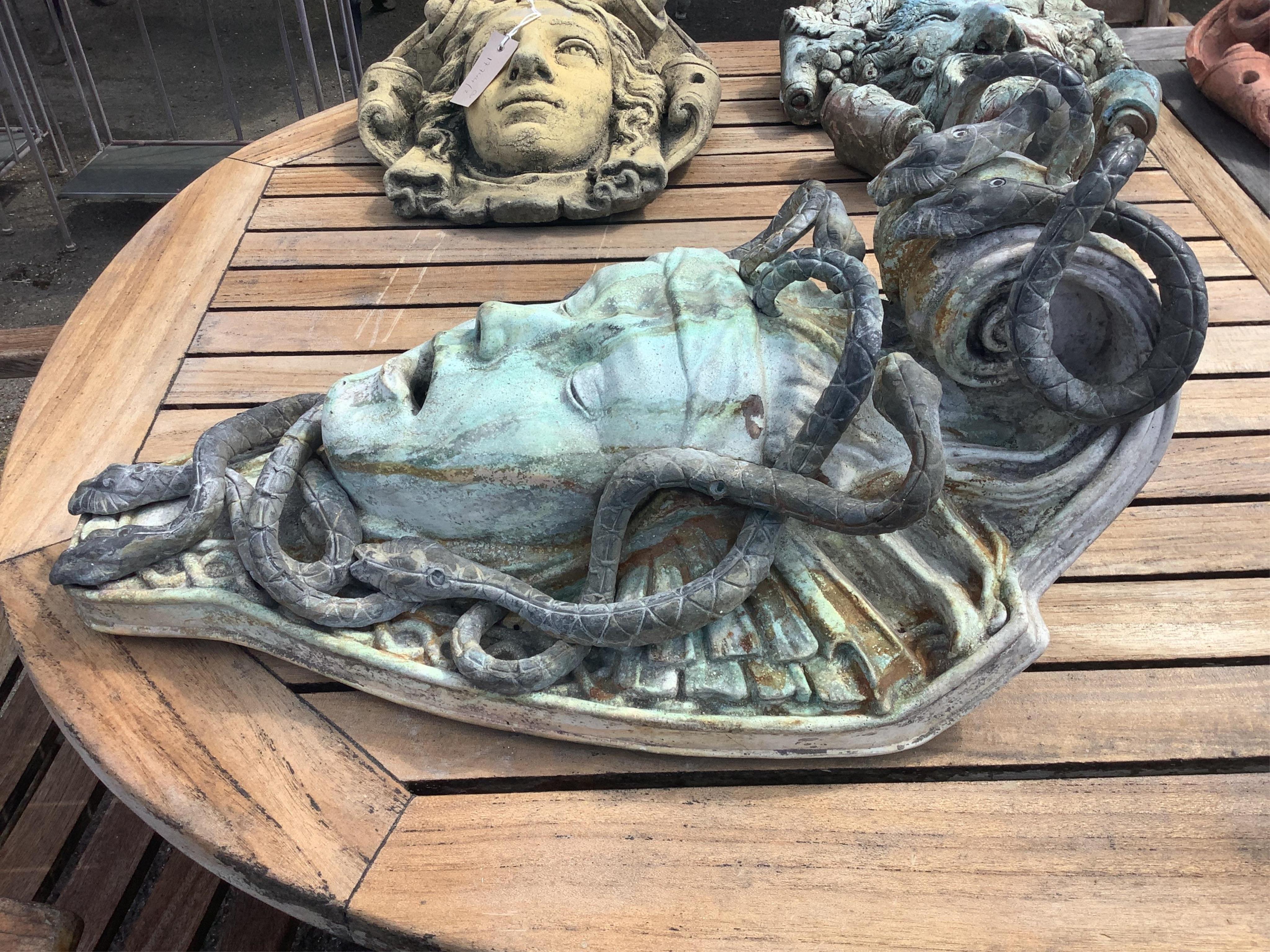 A reconstituted marble and lead Medusa wall fountain head, height 54cm